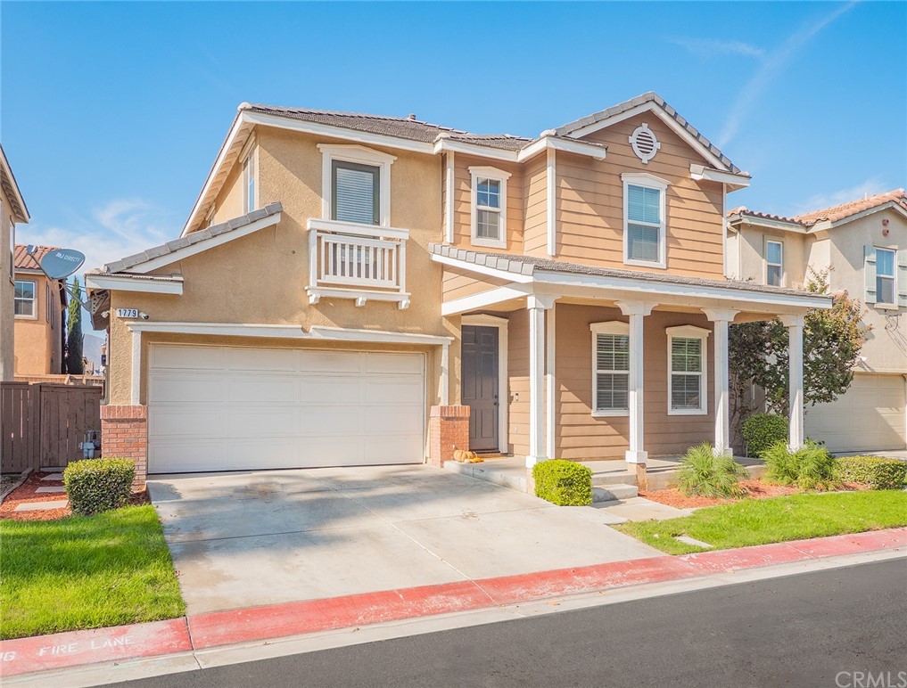 1779 Edmon Way Riverside, CA 92501 - Photo 2 of 63 a front view of a house with a yard and garage