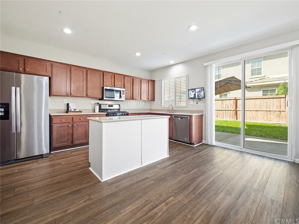 1779 Edmon Way Riverside, CA 92501 - Photo 11 of 63 a kitchen with stainless steel appliances granite countertop a refrigerator a stove top oven and a hard wood floors