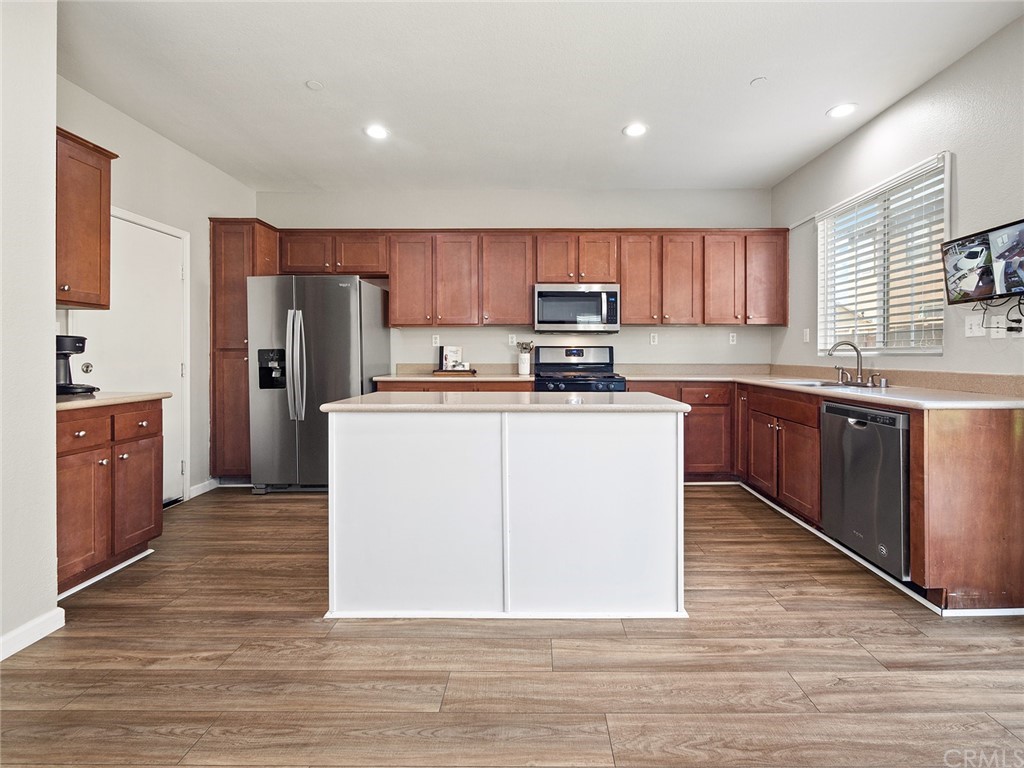 1779 Edmon Way Riverside, CA 92501 - Photo 12 of 63 a kitchen with a sink a refrigerator and cabinets
