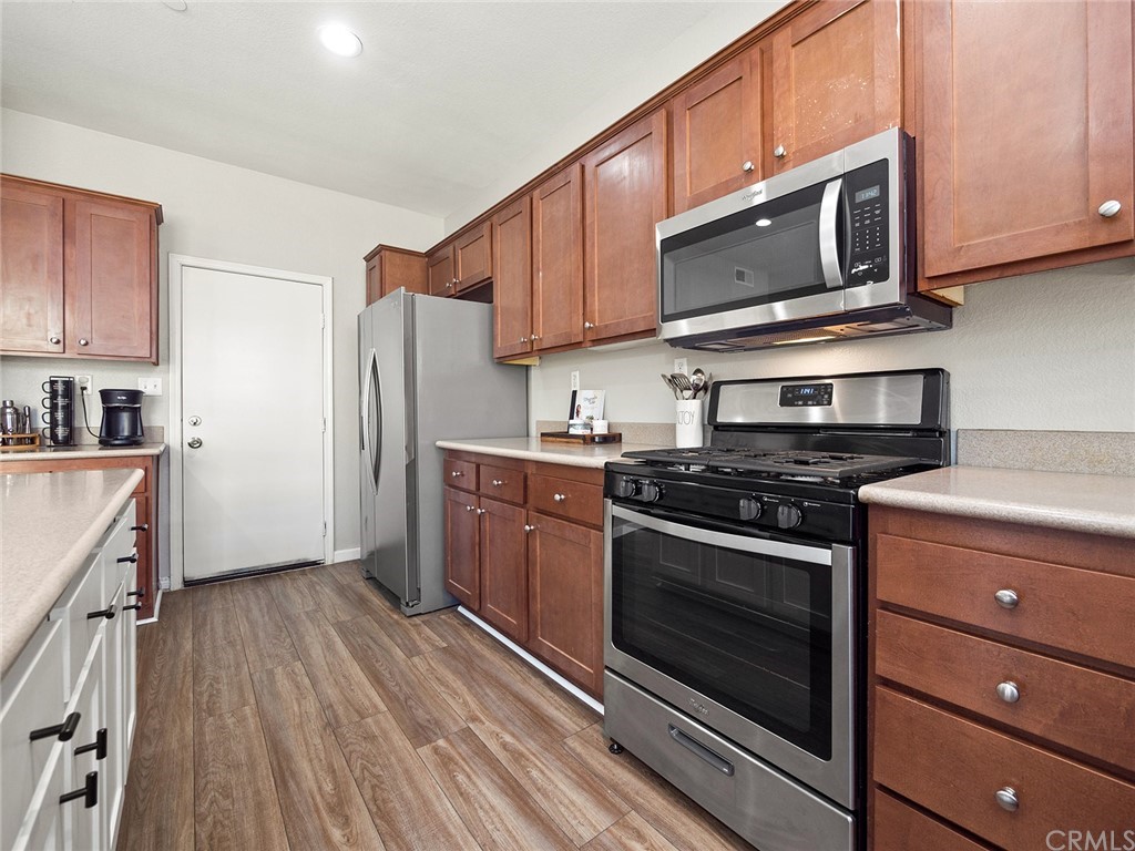 1779 Edmon Way Riverside, CA 92501 - Photo 16 of 63 a kitchen with stainless steel appliances granite countertop a stove microwave and refrigerator