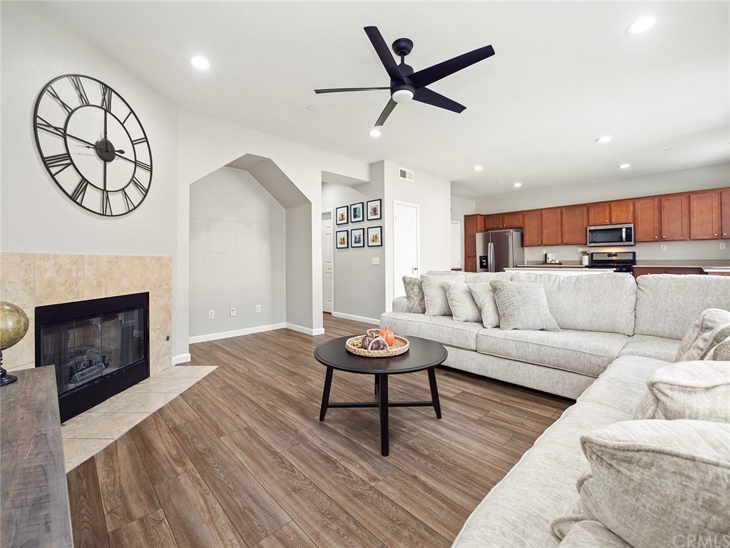 1779 Edmon Way Riverside, CA 92501 - Photo 21 of 63 a living room with furniture a fireplace and a ceiling fan