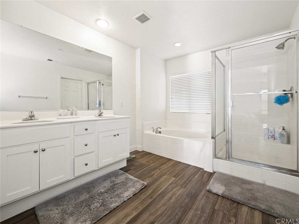 1779 Edmon Way Riverside, CA 92501 - Photo 27 of 63 a spacious bathroom with a double vanity sink a mirror and a bathtub