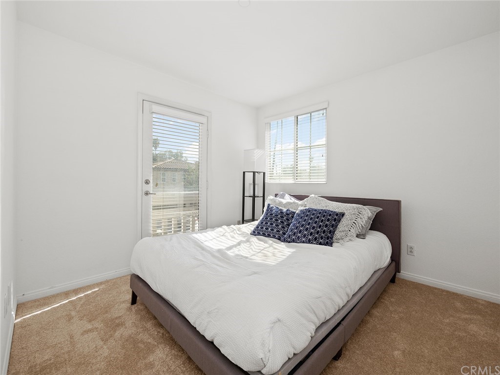 1779 Edmon Way Riverside, CA 92501 - Photo 31 of 63 a bedroom with a bed and a window