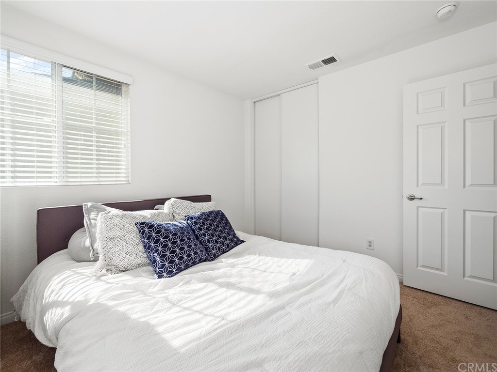 1779 Edmon Way Riverside, CA 92501 - Photo 32 of 63 a bedroom with a bed and a window