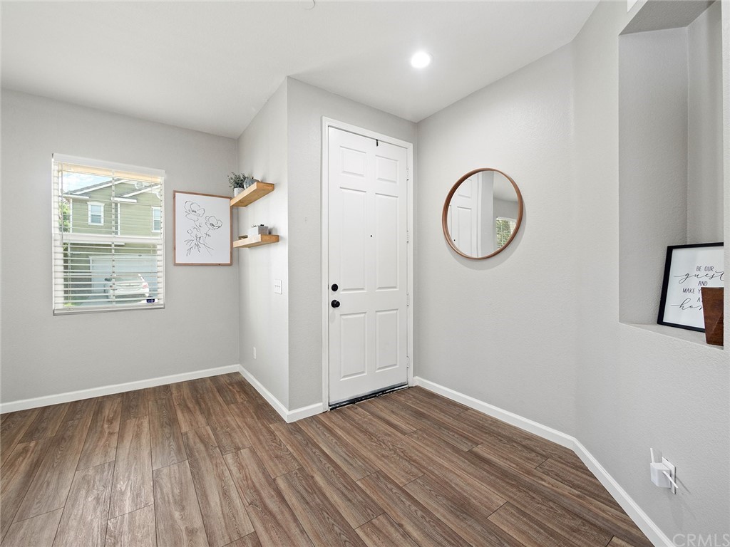 1779 Edmon Way Riverside, CA 92501 - Photo 5 of 63 a view of a room with wooden floor and white walls