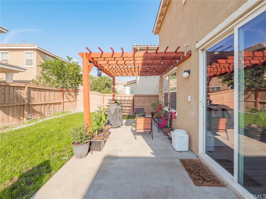 1779 Edmon Way Riverside, CA 92501 - Photo 42 of 63 a view of a patio with table and chairs potted plants