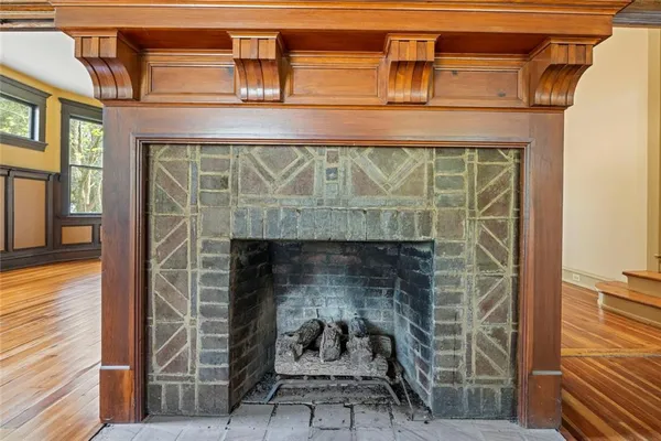 a view of a livingroom with wooden floor and a window