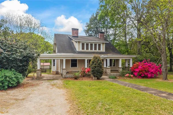 a front view of a house with garden and porch