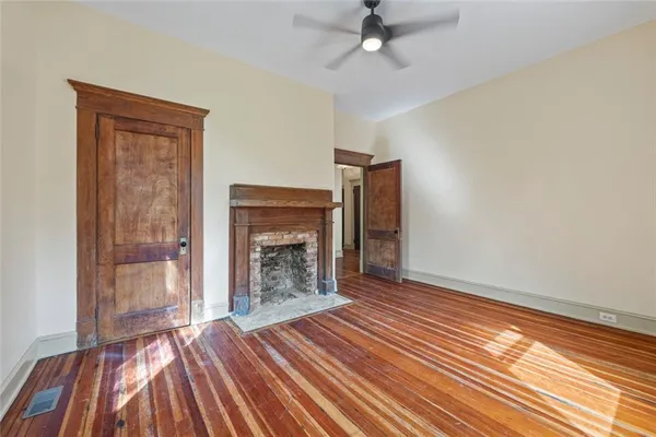 a view of a hallway with wooden floor and staircase