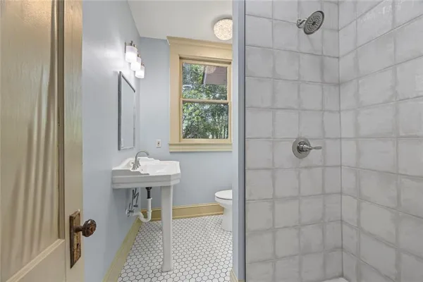 a view of a livingroom with wooden floor and stairs