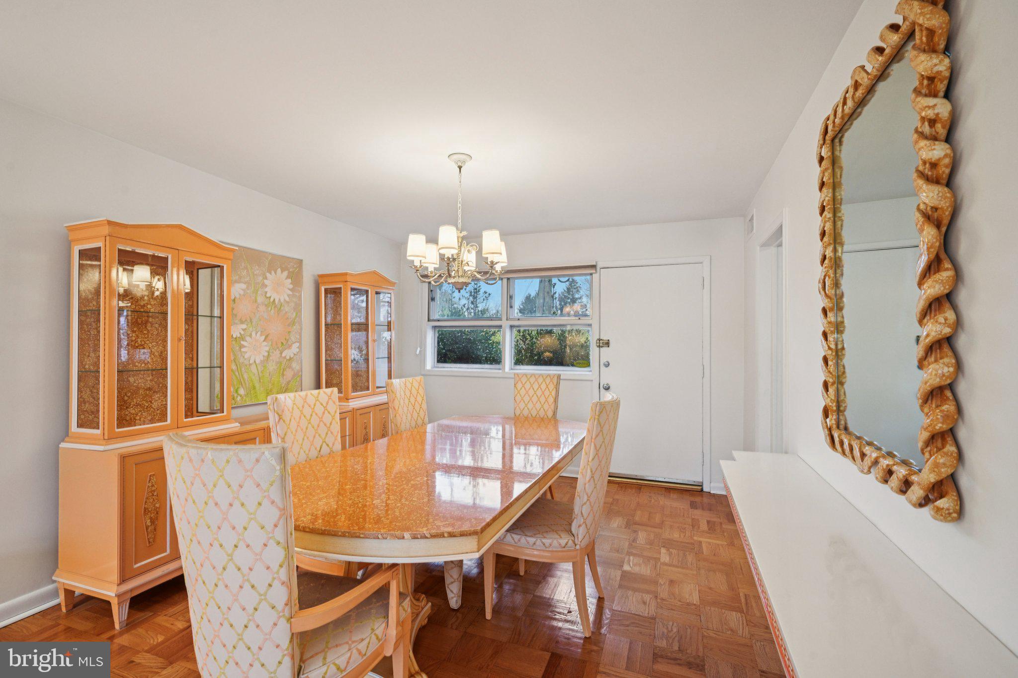 9227 Burbank Road Philadelphia, PA 19115 - Photo 12 of 46 a view of a dining room with furniture wooden floor and chandelier