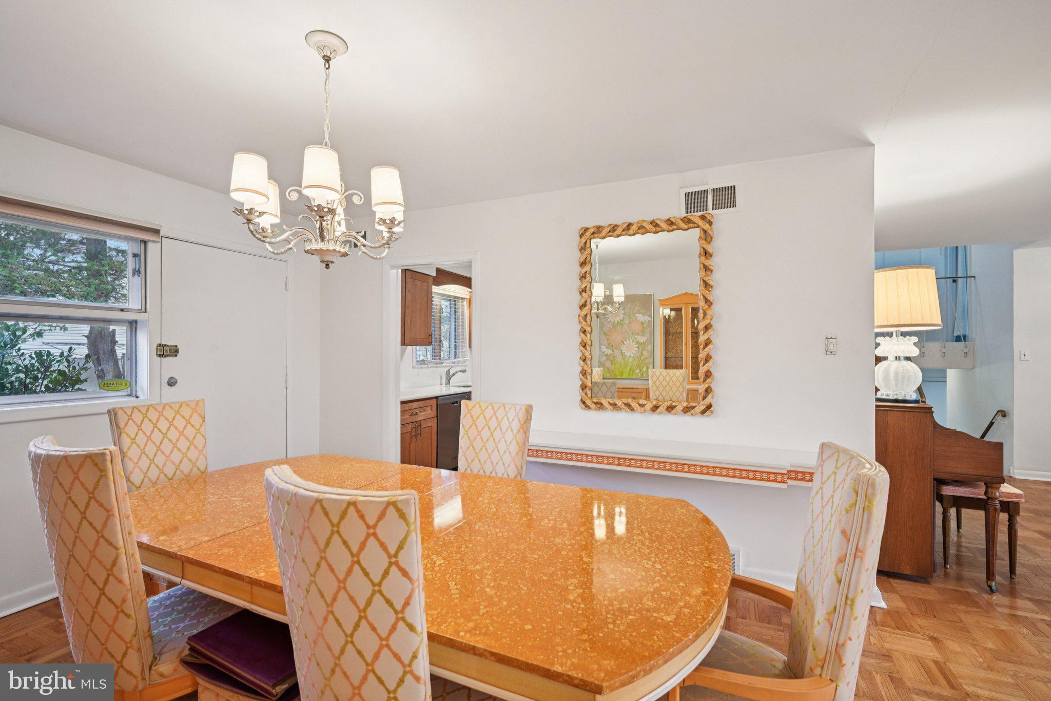 9227 Burbank Road Philadelphia, PA 19115 - Photo 13 of 46 a view of a dining room with furniture wooden floor and chandelier