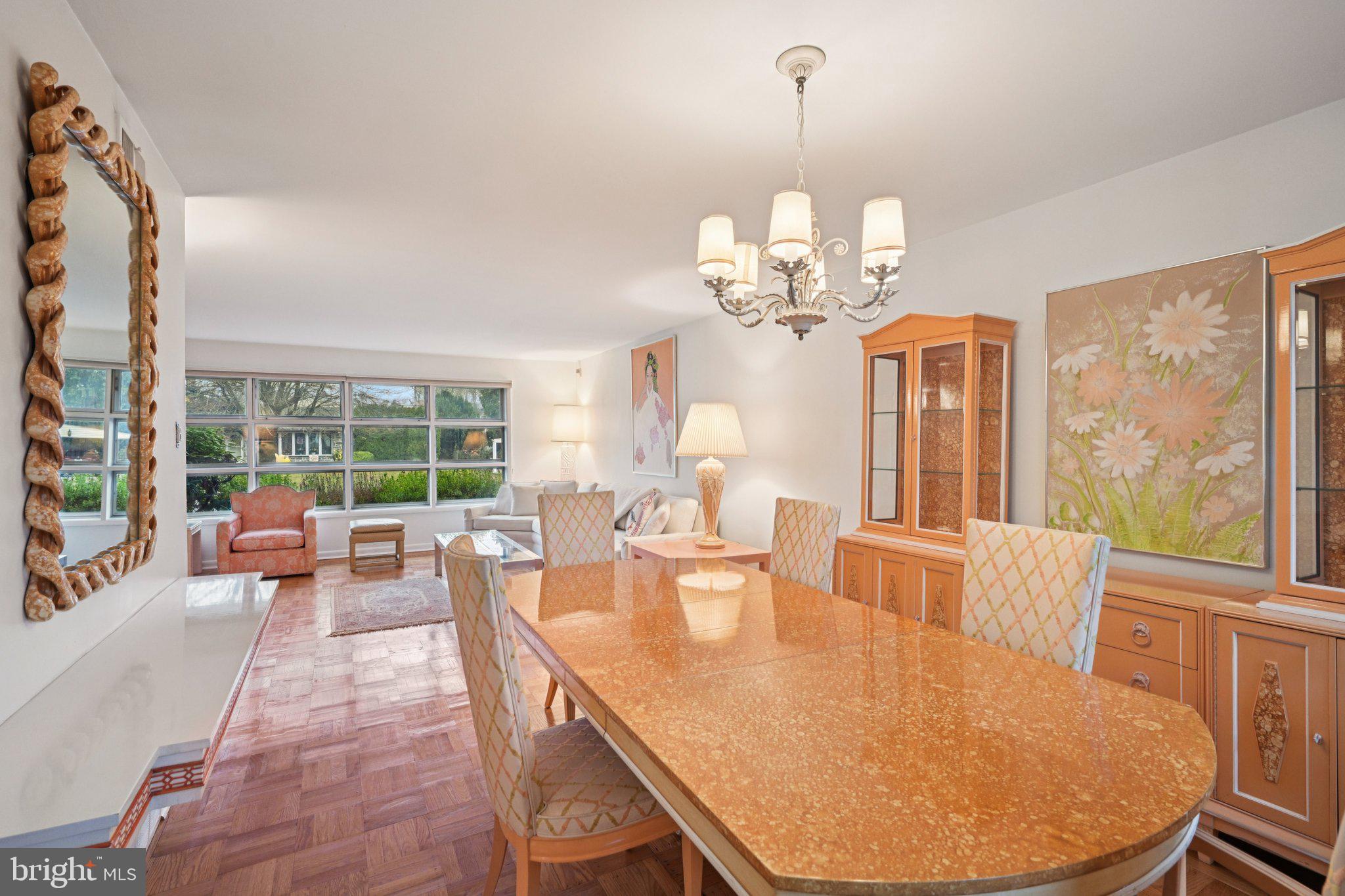 9227 Burbank Road Philadelphia, PA 19115 - Photo 14 of 46 a dining room with wooden floor a chandelier a wooden table and chairs