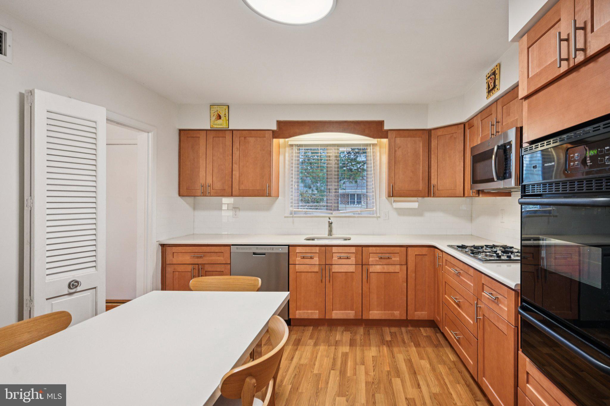 9227 Burbank Road Philadelphia, PA 19115 - Photo 18 of 46 a kitchen with stainless steel appliances a sink stove and cabinets