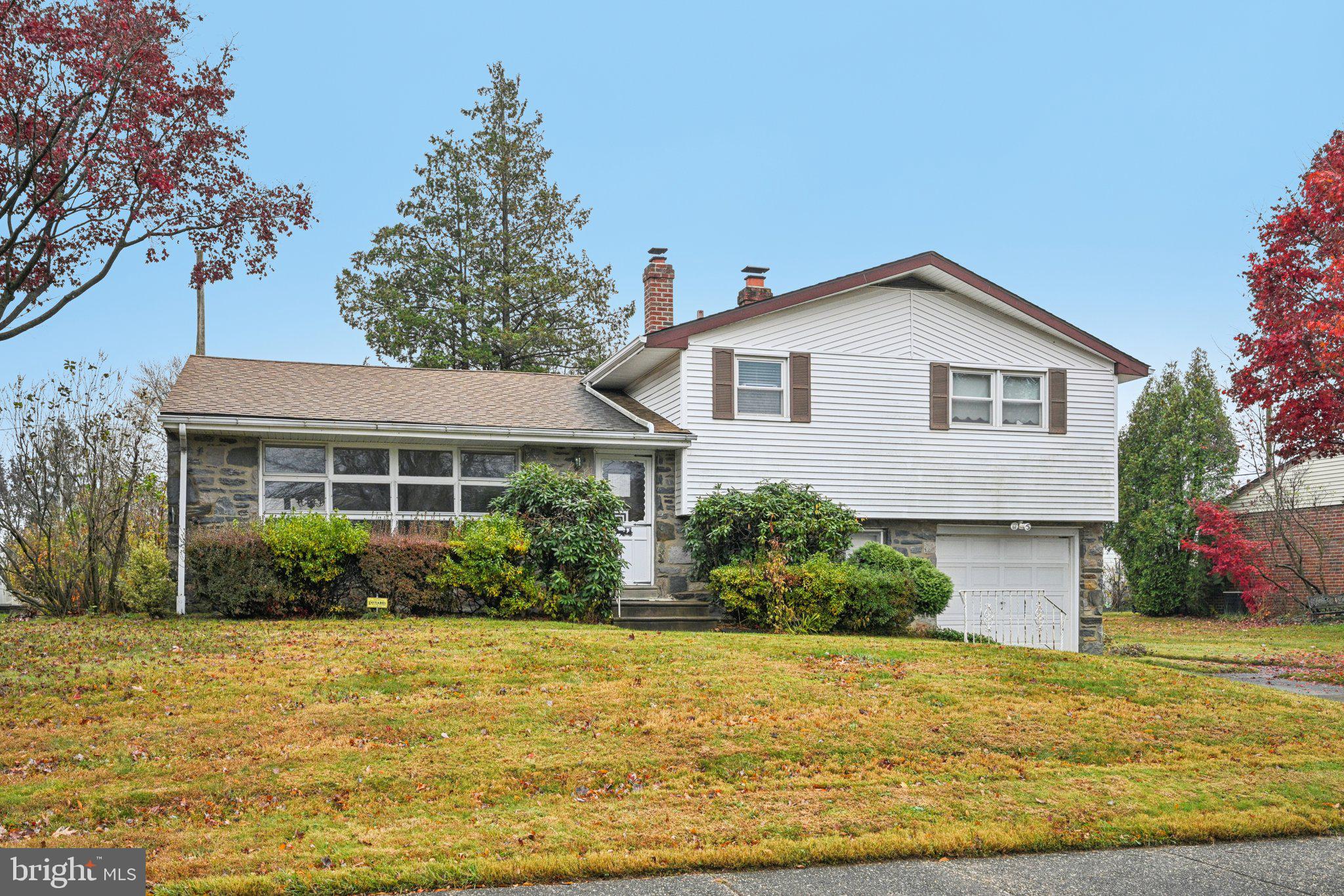 9227 Burbank Road Philadelphia, PA 19115 - Photo 2 of 46 a front view of house with yard and trees around