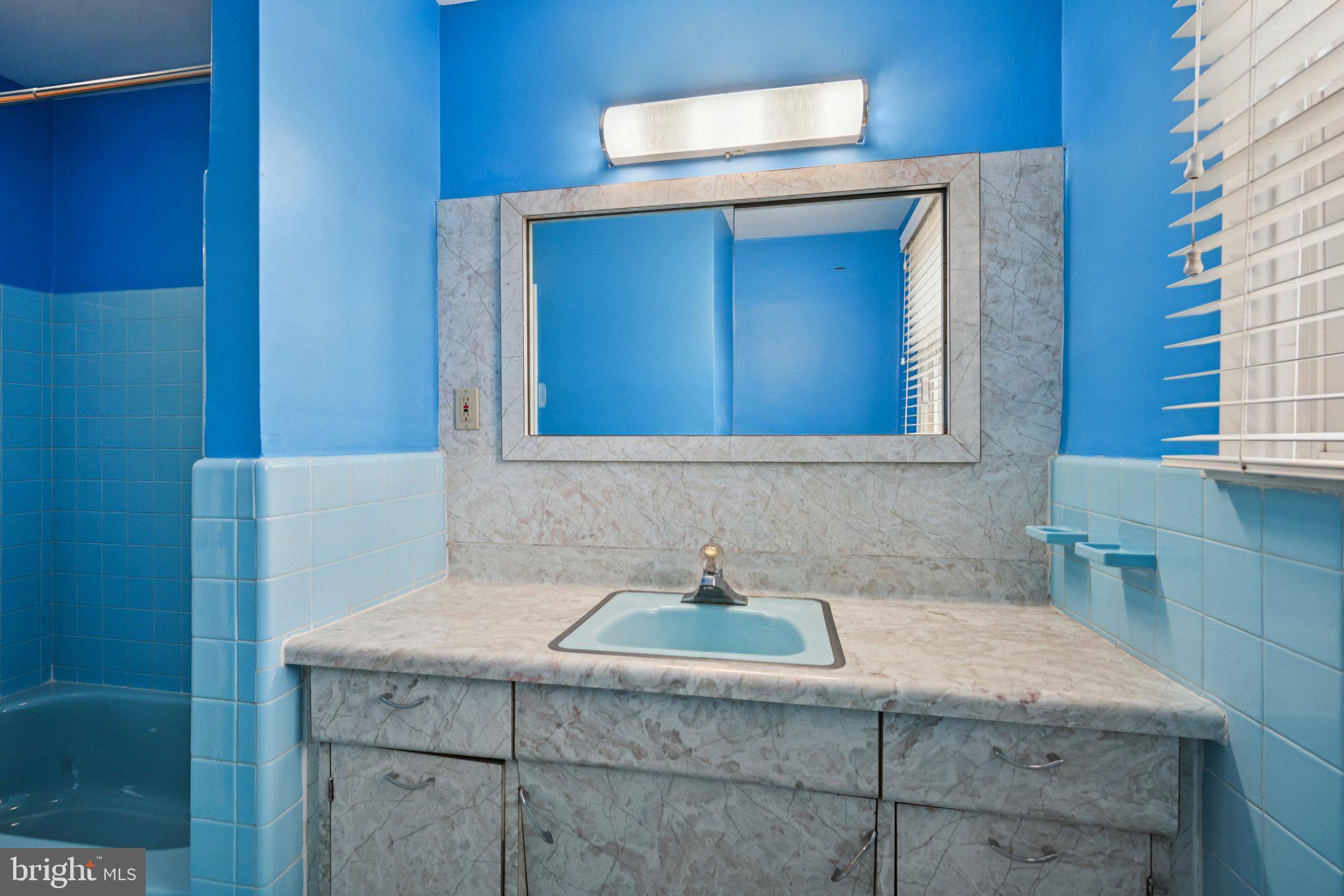 9227 Burbank Road Philadelphia, PA 19115 - Photo 21 of 46 a bathroom with a granite countertop sink and a mirror