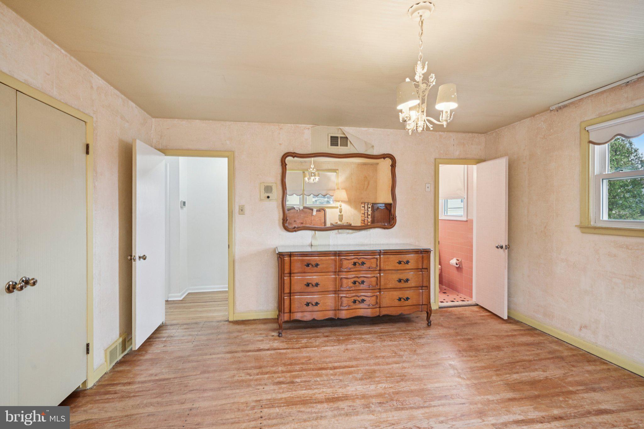 9227 Burbank Road Philadelphia, PA 19115 - Photo 27 of 46 a view of a hallway with a dresser and chandelier