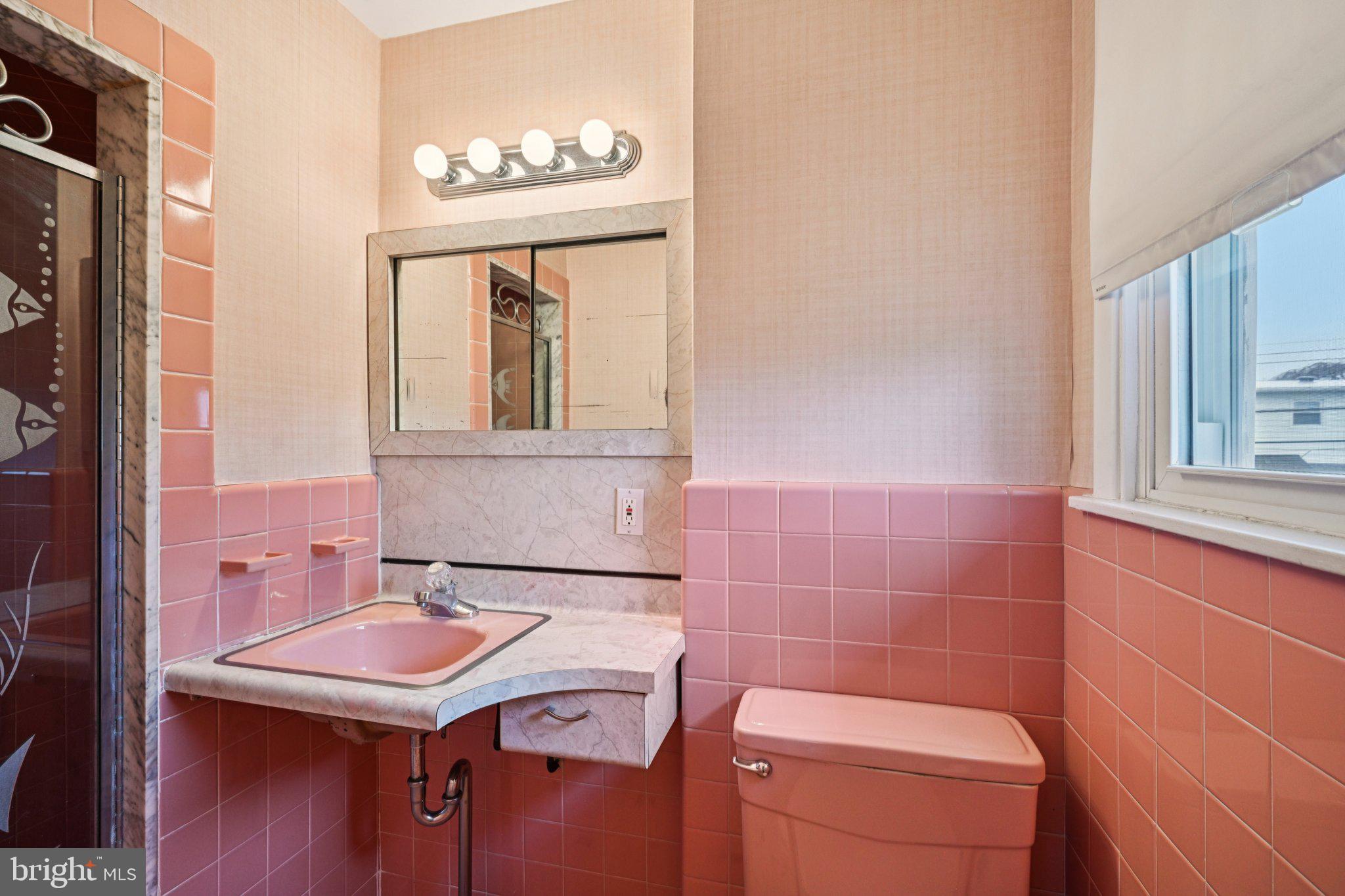 9227 Burbank Road Philadelphia, PA 19115 - Photo 29 of 46 a bathroom with a sink a toilet and a mirror