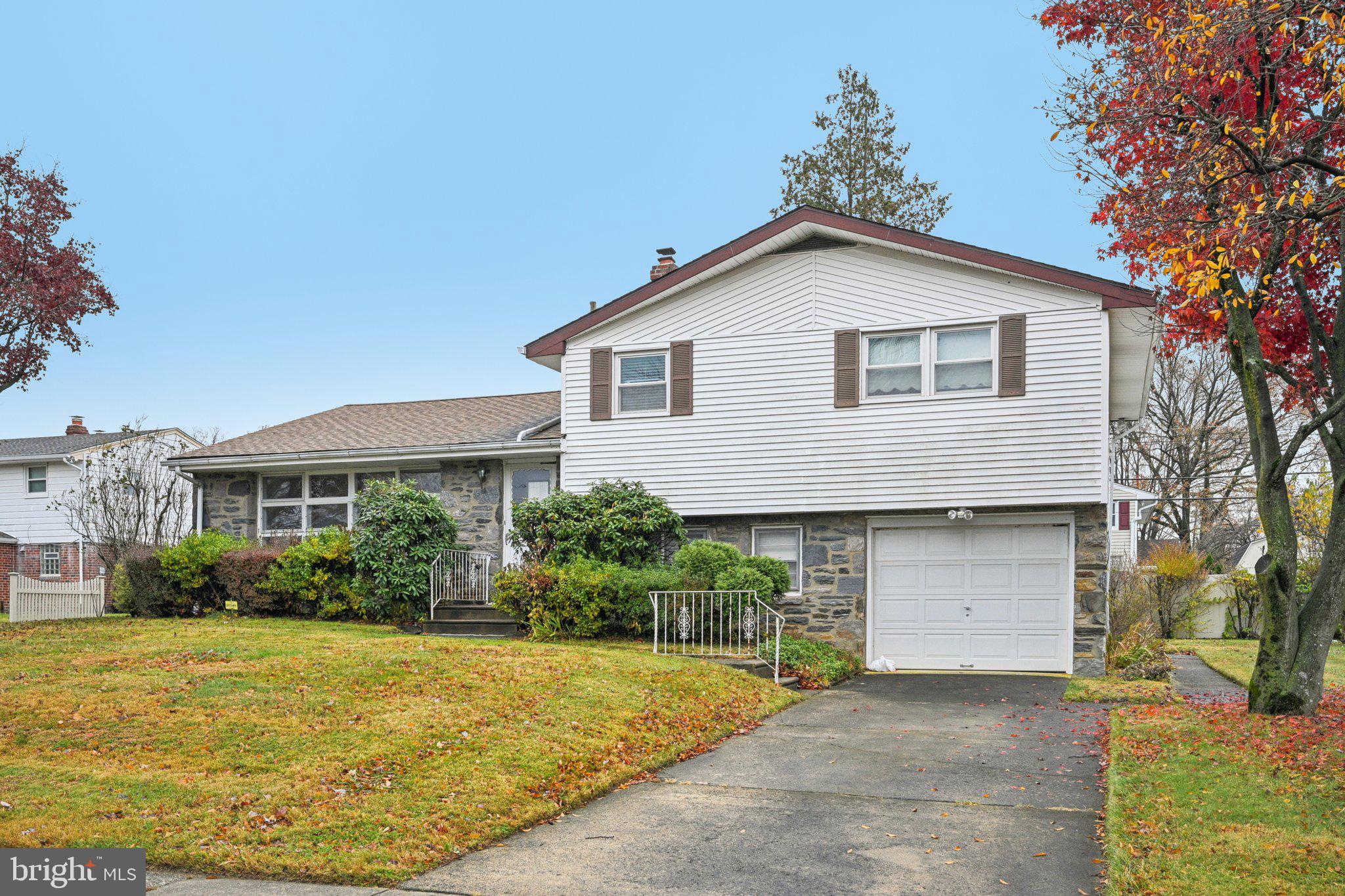 9227 Burbank Road Philadelphia, PA 19115 - Photo 3 of 46 a front view of house with yard and trees around