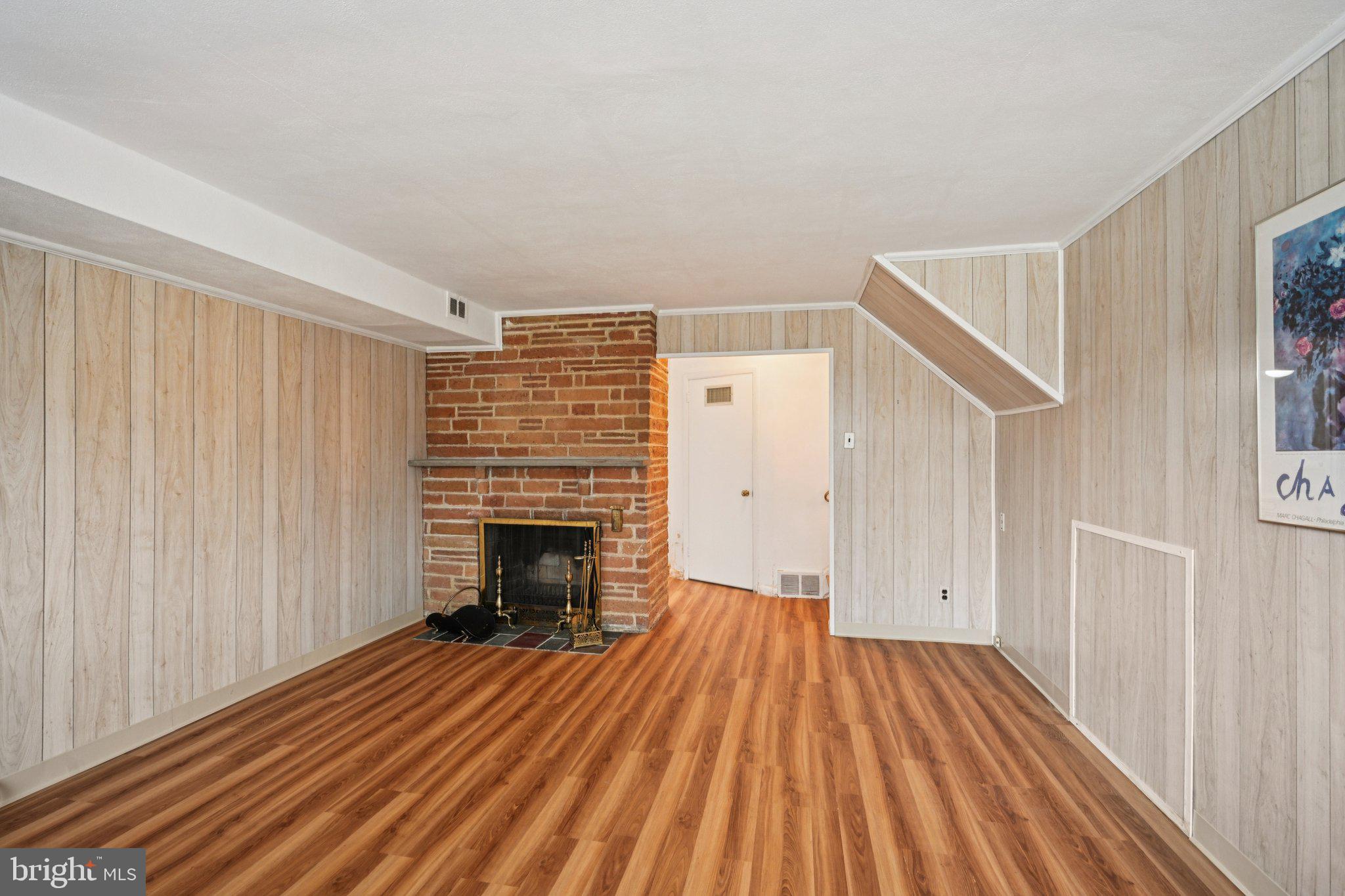 9227 Burbank Road Philadelphia, PA 19115 - Photo 34 of 46 a view of a livingroom with wooden floor and a fireplace
