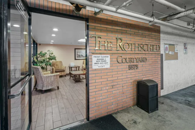 a view of a entryway door of the building and living room