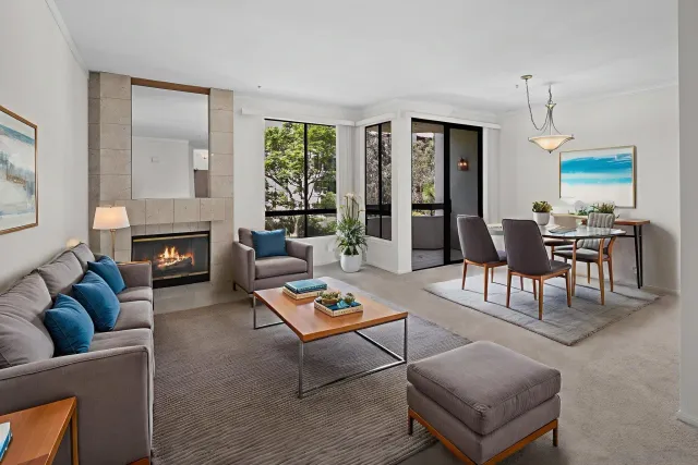 a living room with furniture a table and a fireplace