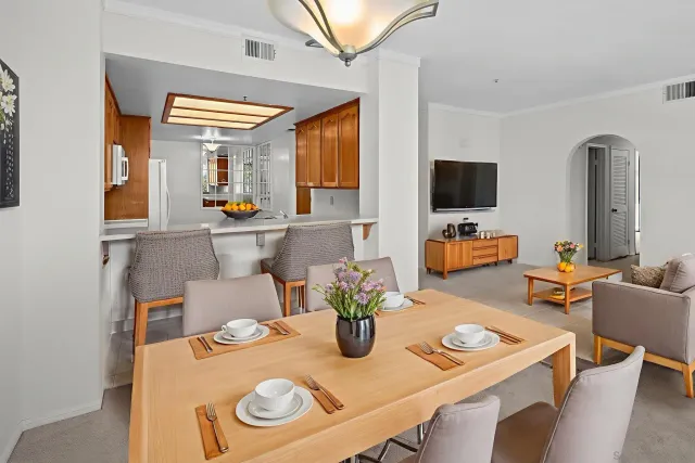a dining room with furniture a flat screen tv and a window