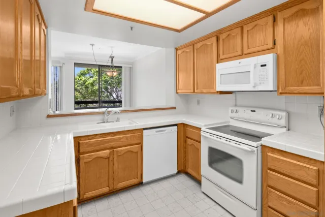 a kitchen with stainless steel appliances granite countertop a sink and a stove top oven