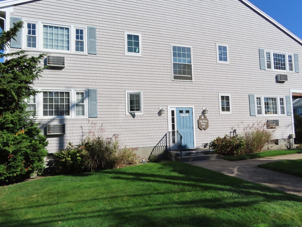 166 Upper County Road, Unit 12 Dennis, MA 02639 - Photo 1 of 9 a view of a house with backyard and plants