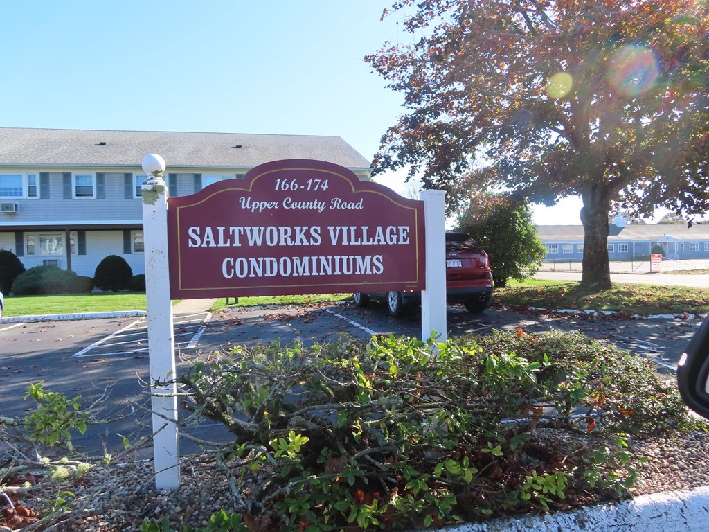 166 Upper County Road, Unit 12 Dennis, MA 02639 - Photo 2 of 9 a sign on the side of a road