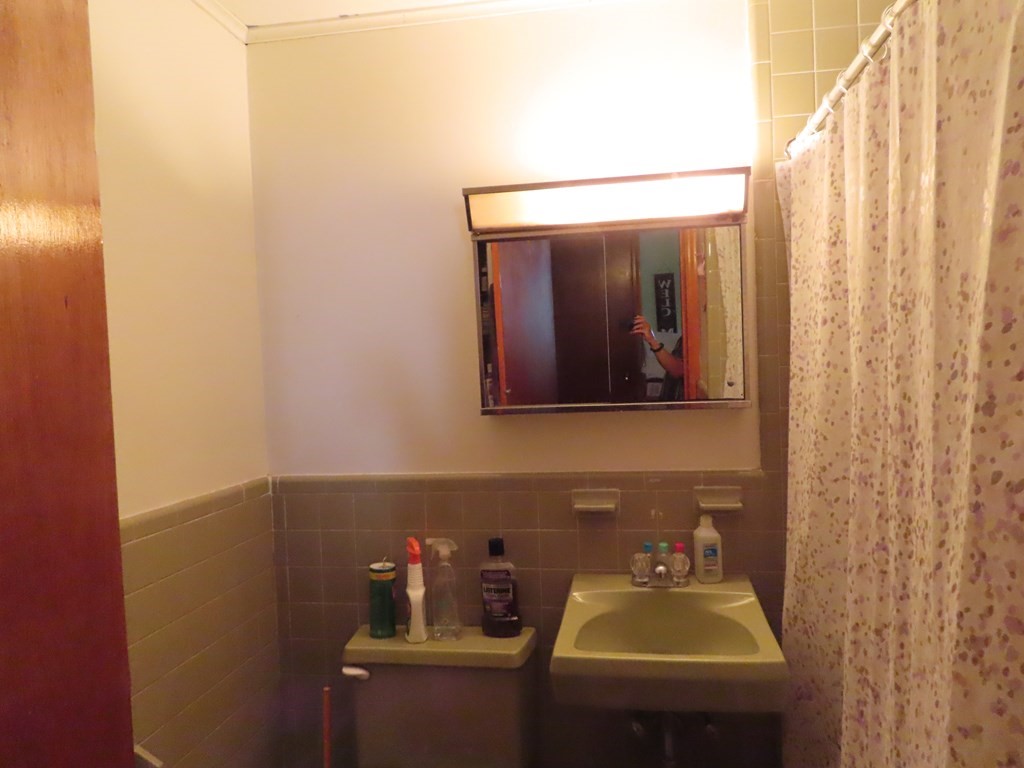 166 Upper County Road, Unit 12 Dennis, MA 02639 - Photo 8 of 9 a bathroom with a sink and a mirror