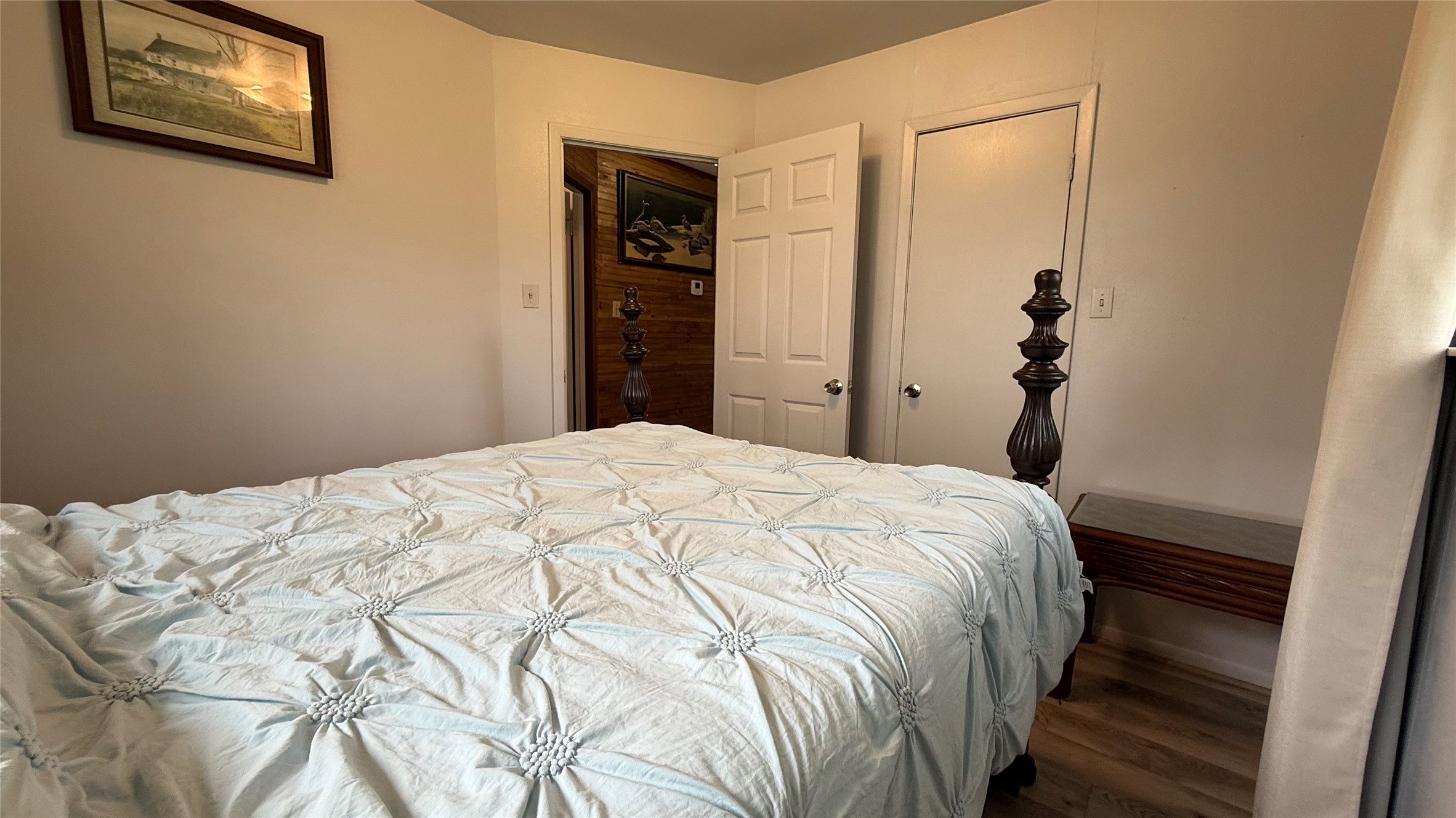 215 Weldon Livingston, TX 77351 - Photo 17 of 22 a bedroom with a bed and a painting on the wall