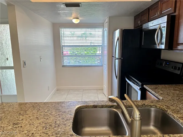 a kitchen with a refrigerator and a sink