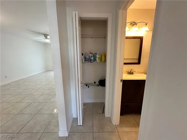 a view of a bathroom from a corridor