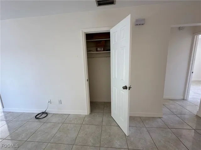 a view of an empty room with closet area