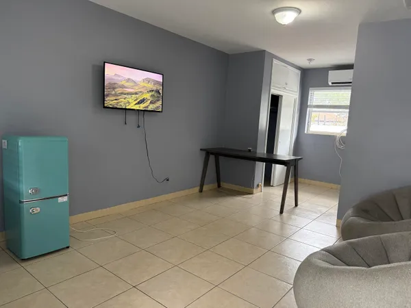 a view of a livingroom with furniture and workspace