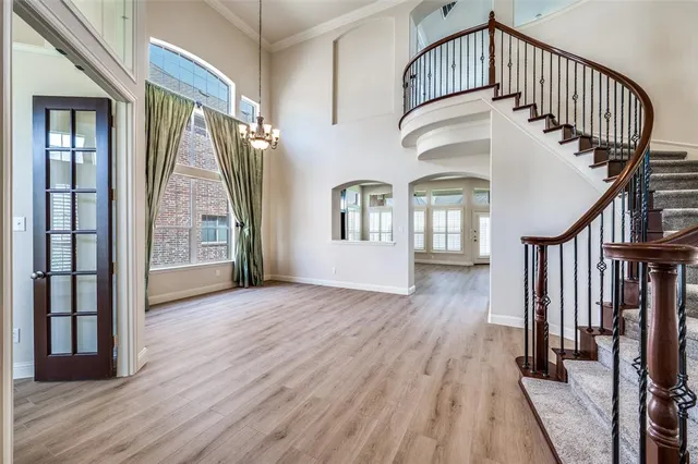 a view of front door with stairs and wooden floor