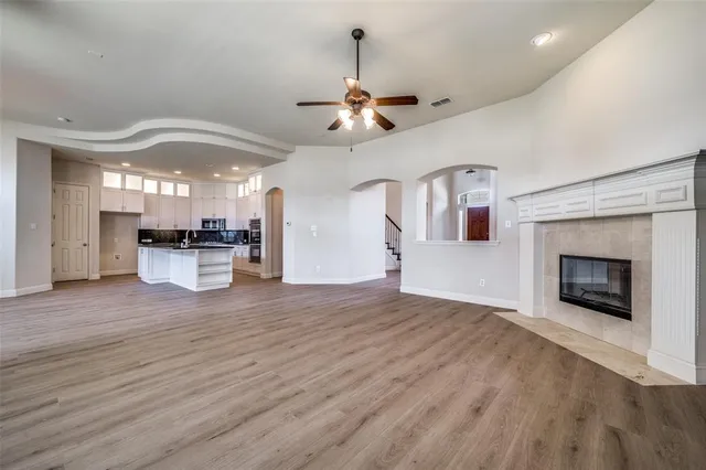 a view of a kitchen with a sink a kitchen a refrigerator and a fireplace