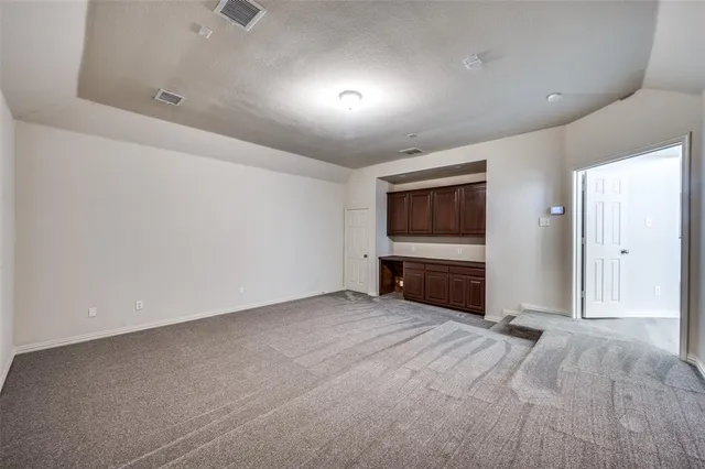 a view of room with walk in closet and wooden floor