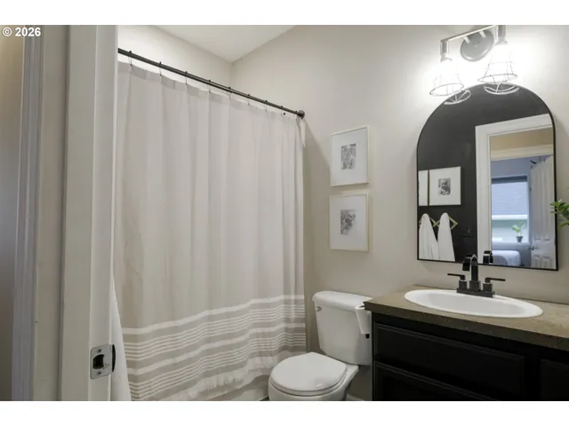 a bathroom with a sink a mirror and a toilet