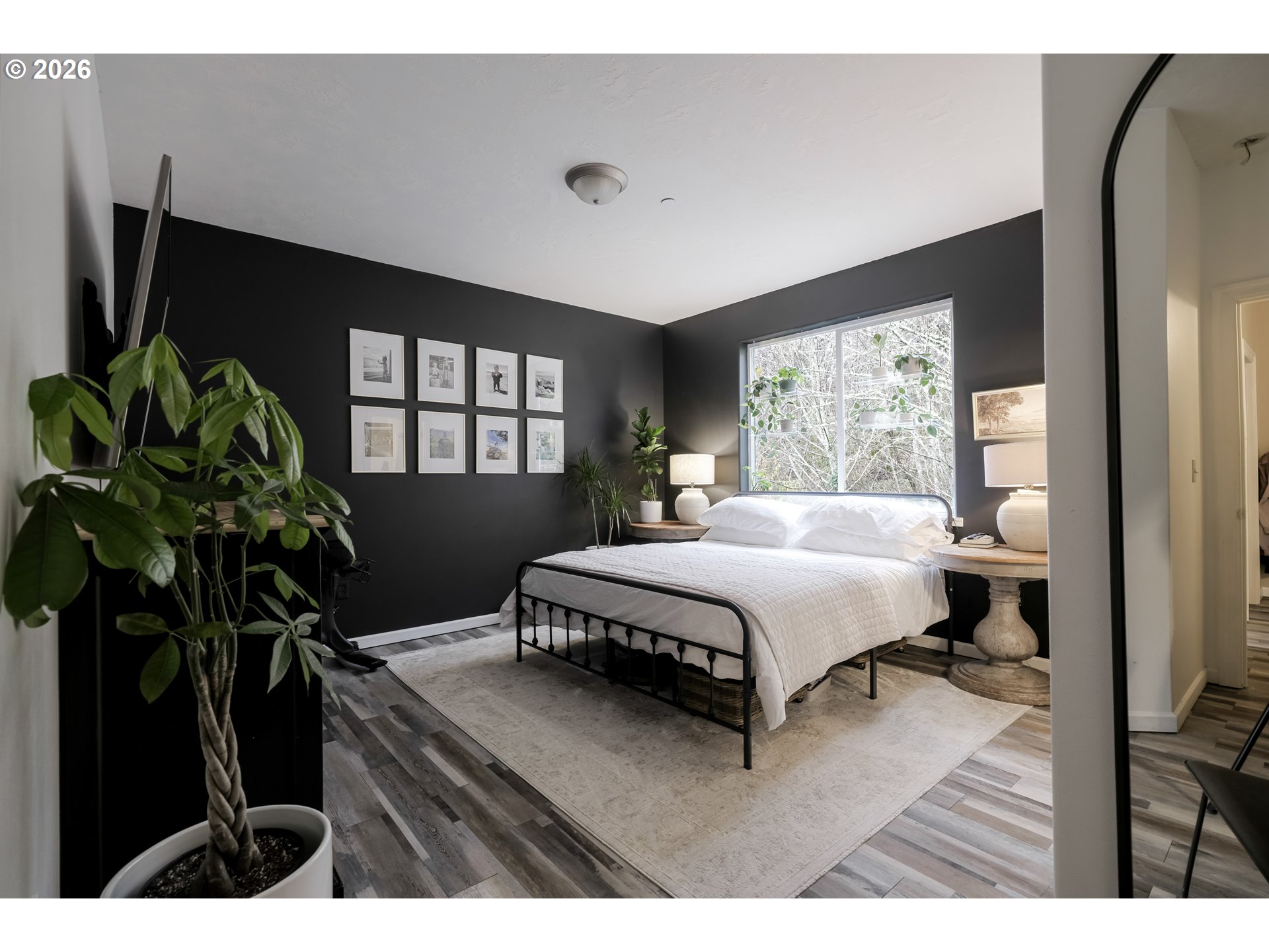 1732 Southeast 3rd Street Astoria, OR 97103 - Photo 17 of 30 a bedroom with a bed window and potted plant on table