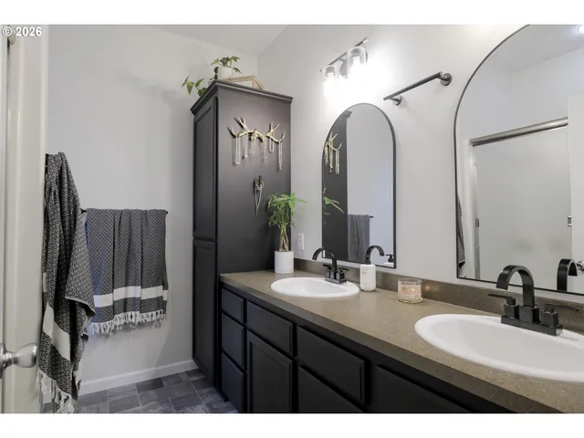 a bathroom with a double vanity sink and a mirror