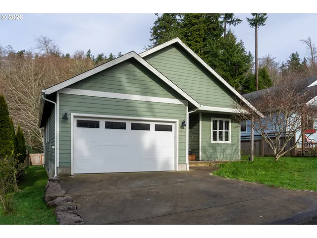 a view of house with backyard space and garden