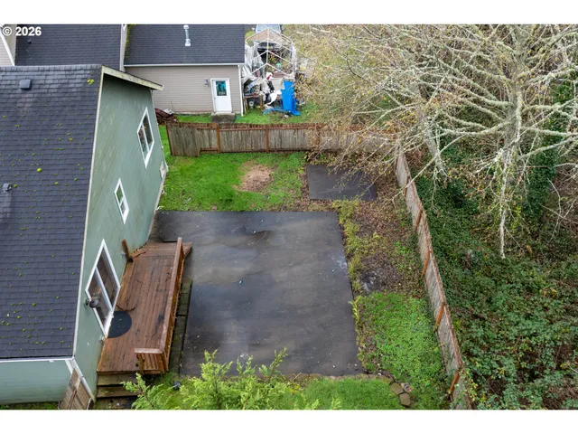 an aerial view of a house with a yard basket ball court and outdoor seating
