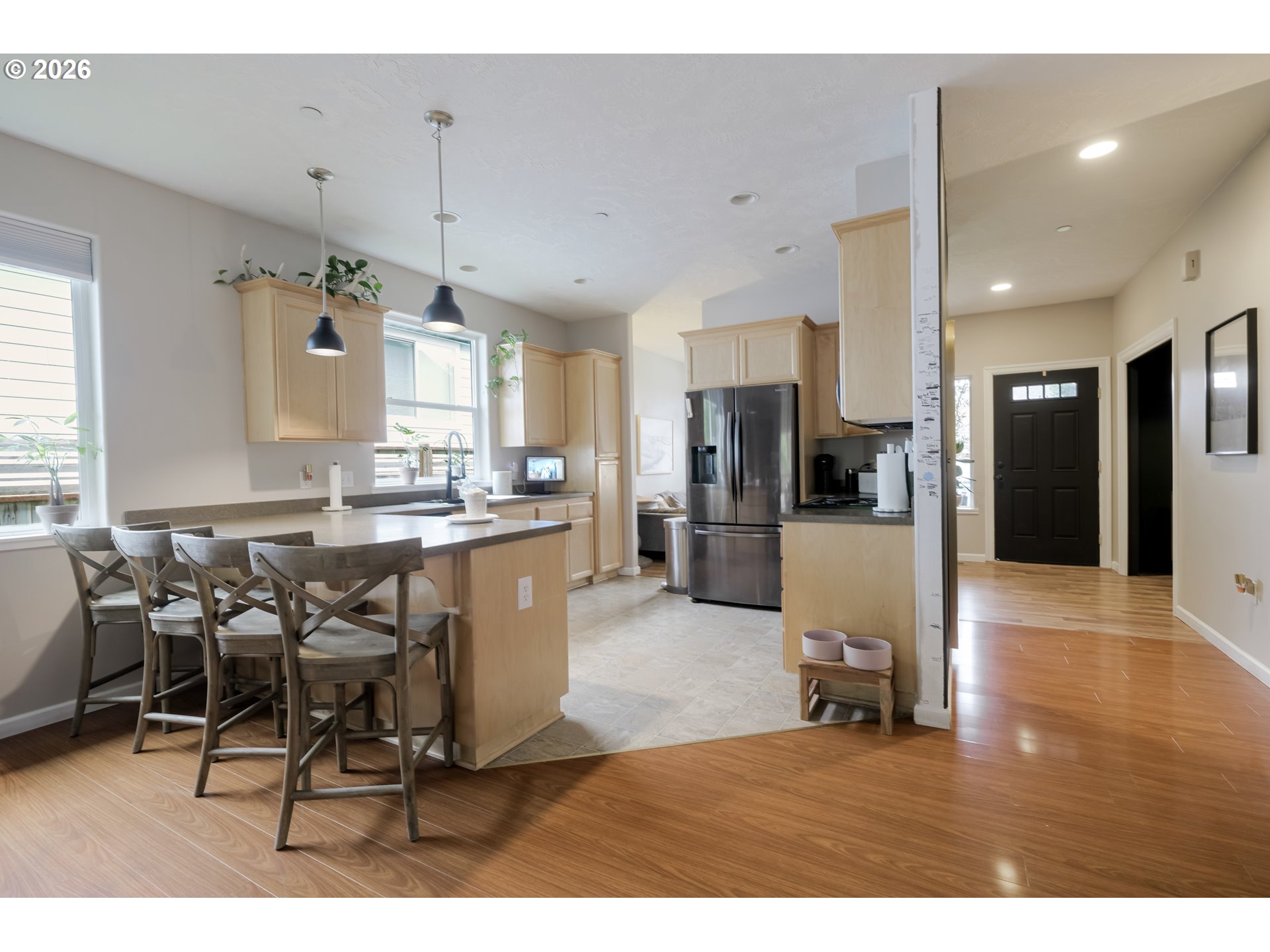 1732 Southeast 3rd Street Astoria, OR 97103 - Photo 8 of 30 a kitchen with stainless steel appliances kitchen island granite countertop a refrigerator a stove a sink and white cabinets with wooden floor