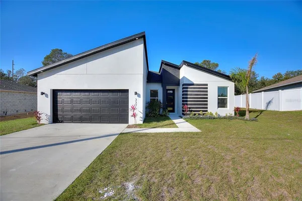 a front view of a house with a yard and garage