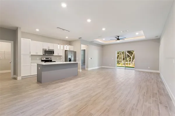 a kitchen with stainless steel appliances a sink stove refrigerator and cabinets