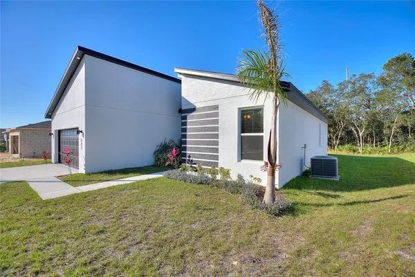 a view of a house with a yard and garage