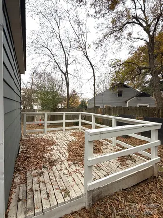 a view of a backyard with wooden fence