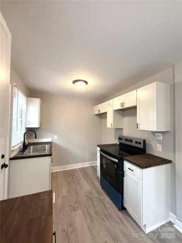 a kitchen with granite countertop a sink and cabinets